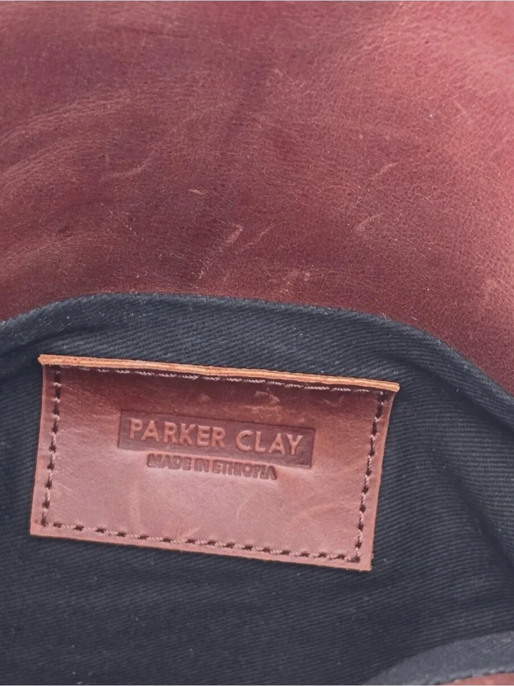 •Parker Clay • Nyala Fold over leather clutch rust
